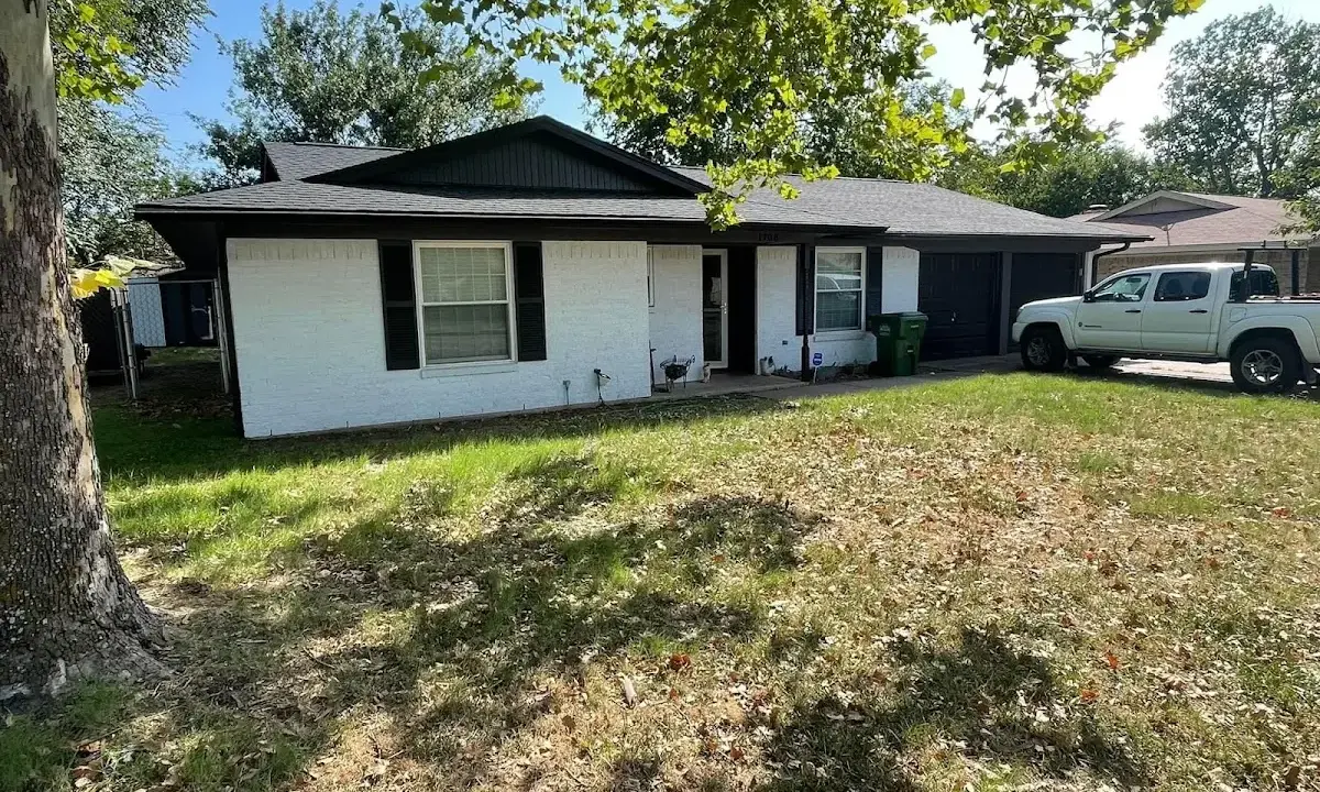 Professional roofing crew working on a residential roof in Leitchfield